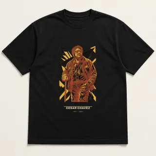 Front of a black tee carrying the civic modern Cesar Chavez design
