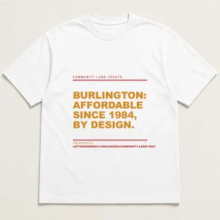 Front of a white tee reading "Burlington: affordable since 1984, by design." with the Community Land Trusts page address printed under it