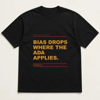 Front of a black tee reading "Bias drops where the ADA applies." with the Disability rights page address printed under it